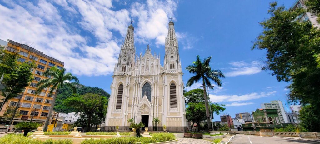 Catedral Metropolitana de Nossa Senhora da Vitória, um templo em estilo neogótico. Ela tem uma fachada branca adornada com detalhes esculpidos e duas torres laterais.