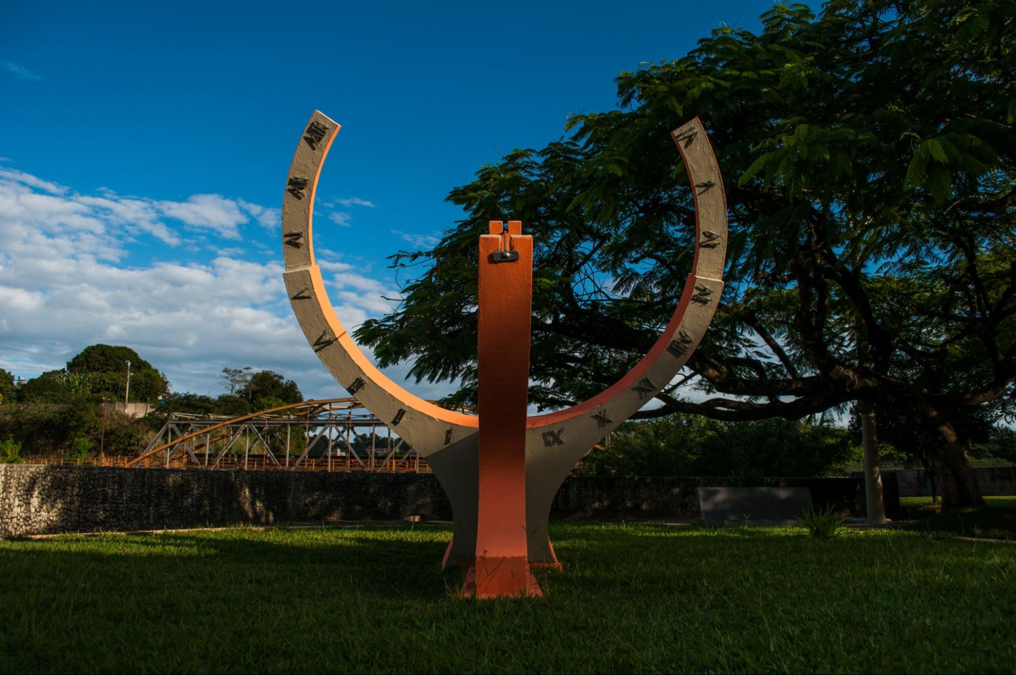 Relógio do Sol em Divinópolis MG. Escultura em forma de ferradura apontada para cima com os números romanos para indicar as horas.